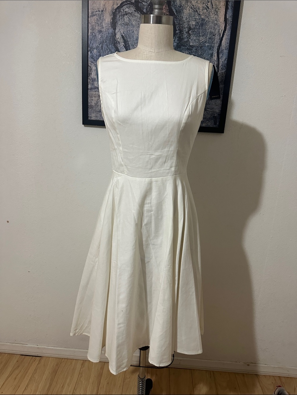 Elegant White Sleeveless Midi Dress with Flared Skirt